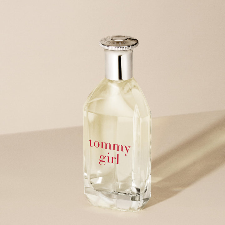 Clear curved 100 ml perfume bottle with silver cap, floral-woody scent for Women