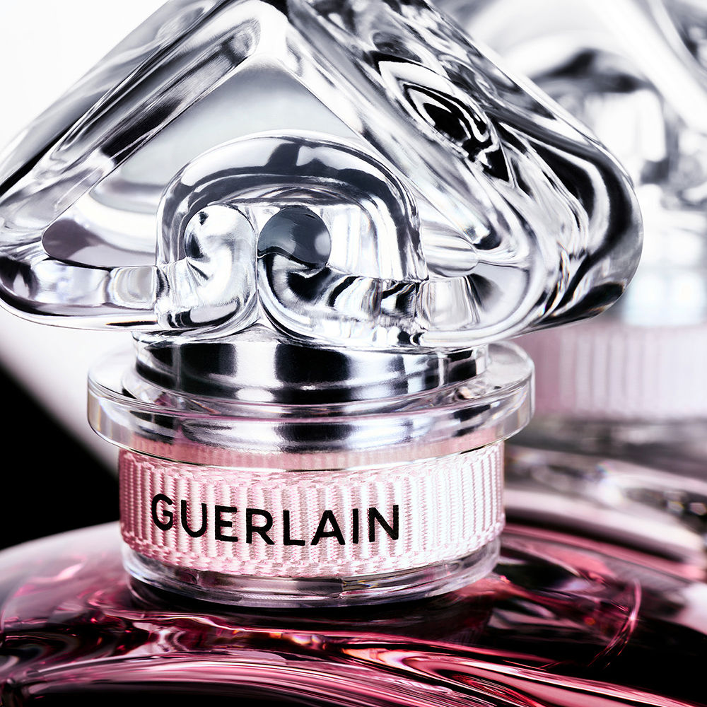 Clear glass 75 ml perfume bottle with blue liquid and inverted‑heart cap