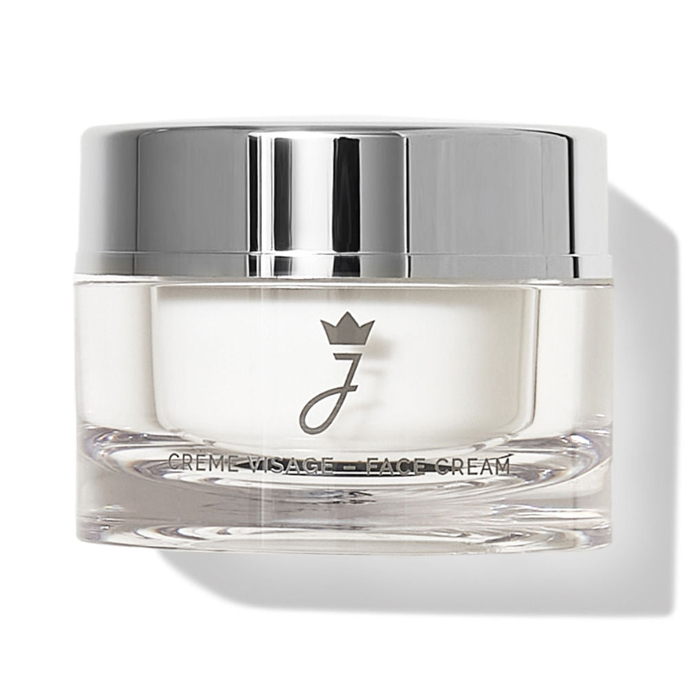Jacadi Silver metallic‑lidded cylindrical jar with transparent base, white cream visible, logo crown and printed text