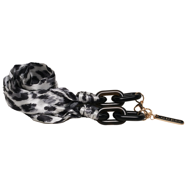 Black and gold cat-eye eyeglasses with thin metal temples and patterned fabric strap laid on white background