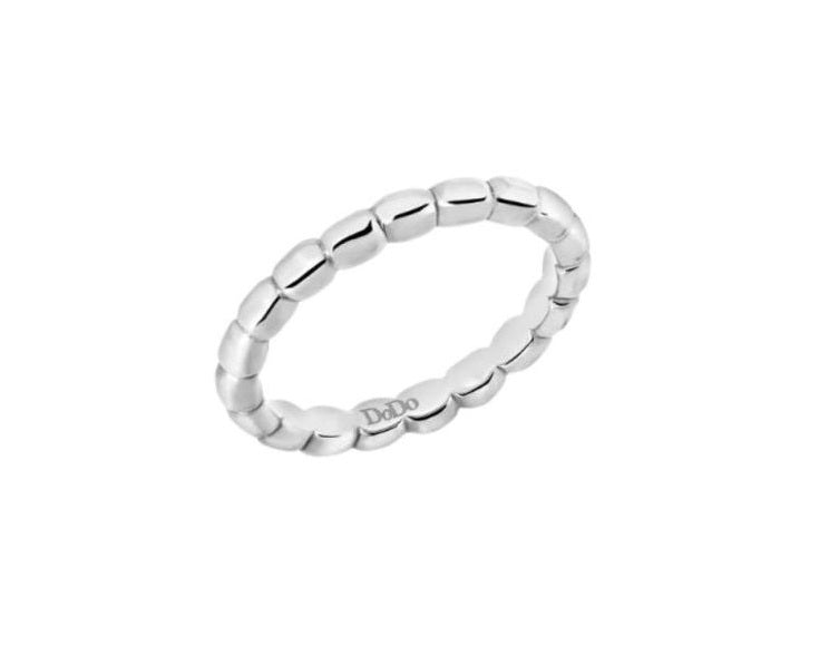 Close-up of minimalist sterling silver beaded ring with polished smooth finish on neutral background