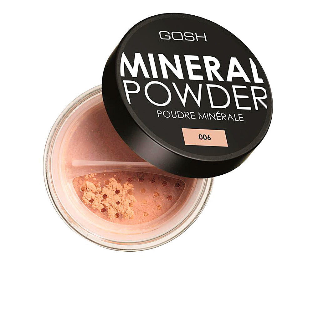 Jar of ivory mineral loose powder with fine, matte texture, brush suggested
