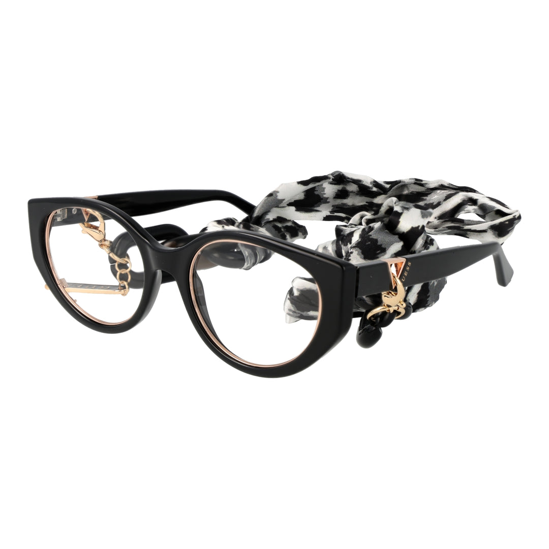 Black and gold cat-eye eyeglasses with thin metal temples and patterned fabric strap laid on white background
