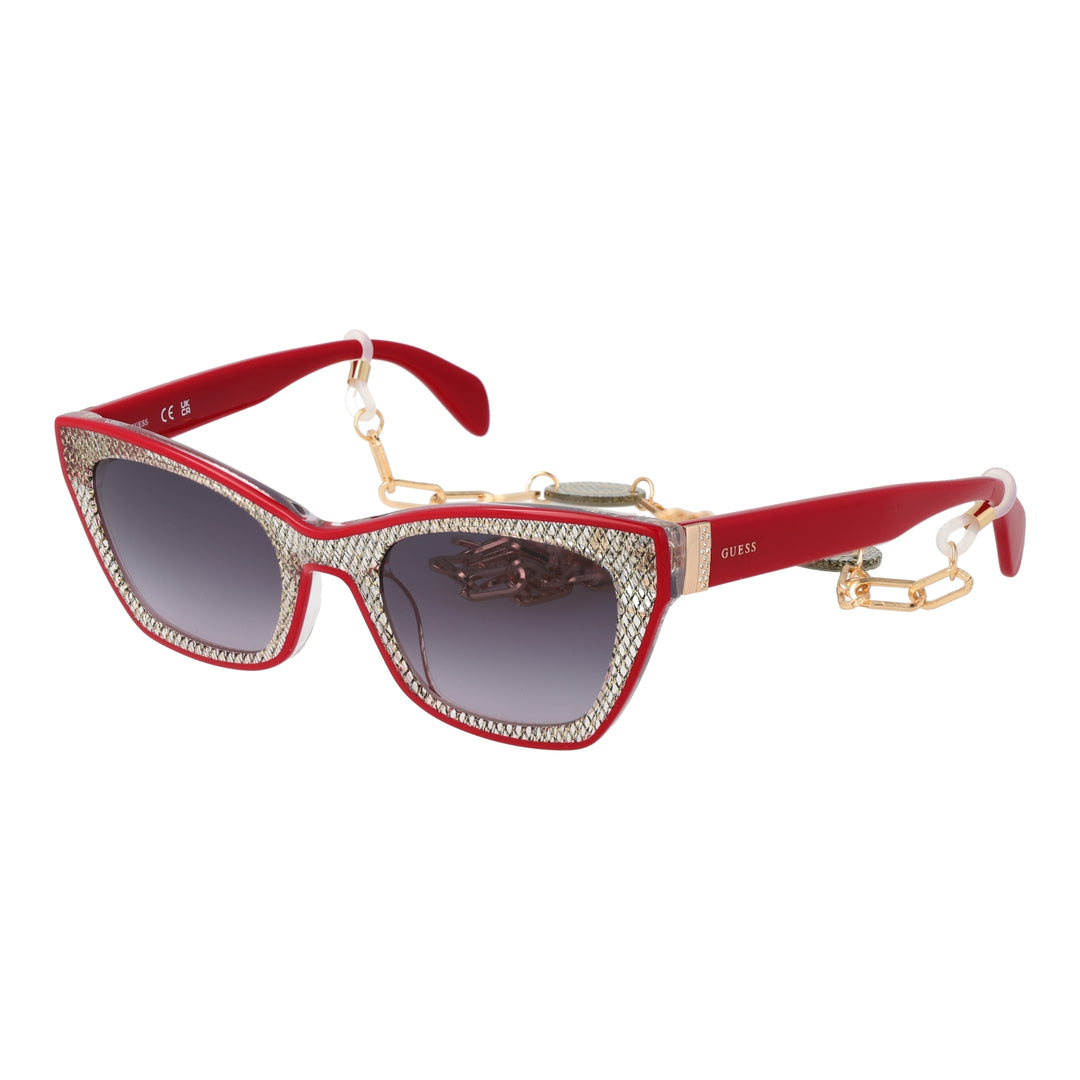 Red and black textured cat-eye sunglasses with gradient grey lenses and decorative gold chain over a neutral background