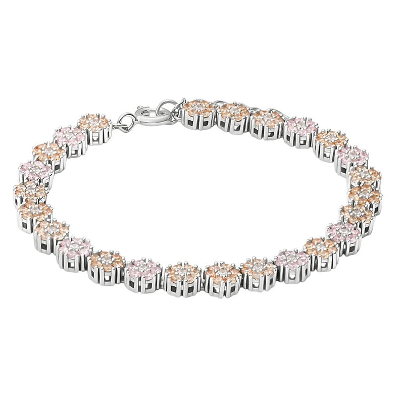 Silver link bracelet with alternating pink and peach floral gemstone clusters on wrist